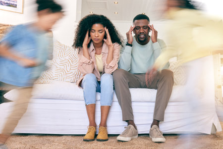 Children, running and tired parents on sofa with motion blur for energy, playing and hyper kids in living room. Black family, stress and mom and dad with headache, frustrated and fatigue at homeの写真素材