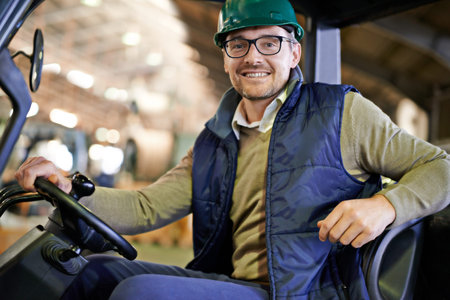 Rolling around the factory floor. a forklift driver in a warehouse.