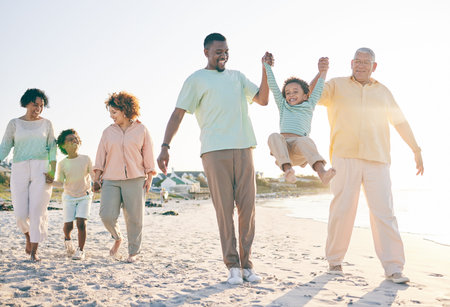 Family, grandparents and kids at beach, holding hands and jump with swing, happiness or bonding on...