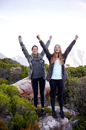 We made it. Portrait of two excited young female hikers in the outdoors.の写真素材