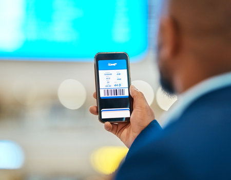 Qr code, travel and man with a phone for a ticket, airplane booking and information at the airport. App, website and hand of a businessman reading a barcode on a mobile for a work trip or vacationの写真素材