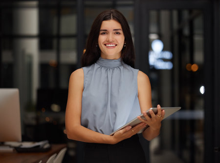 Happy, night and tablet with portrait of woman in office for search, communication and digital management. Contact, technology and smile with employee for website, networking and social media appの写真素材