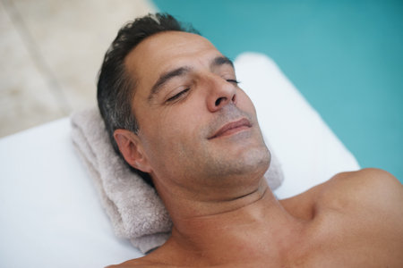 Complete calm and relaxation made easy. a handsome mature man enjoying a massage at a spa.の写真素材