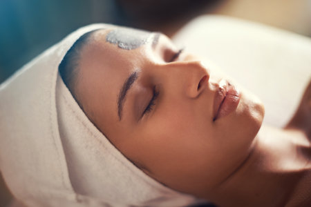 Finding serenity at the spa. a beautiful young woman relaxing during a beauty treatment a a spa.の写真素材