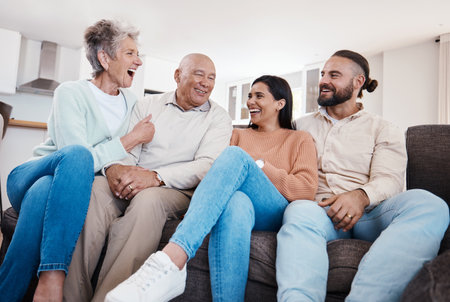 Parents, couple and happy family bonding in a home or house together spending quality time sitting on a couch or sofa. Elderly, holiday and people relax and visit on vacation being carefreeの写真素材