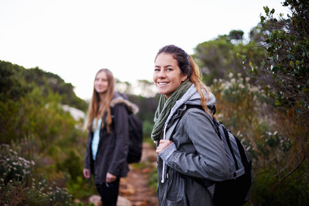 Time for an adventure. two attractive young female hikers in the outdoors.の写真素材
