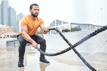 Outdoor, exercise and man with ropes, workout or training for wellness, fitness or healthy...
