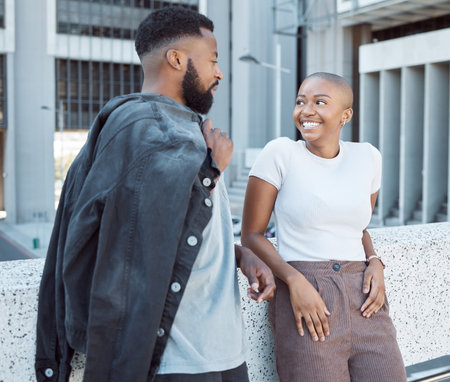 Talking, black people and couple of friends in a city with happiness and conversation outdoor. Urban lifestyle, happy woman and communication by a building with partner and smile from discussionの写真素材