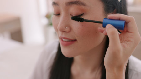 Makeup, mascara and Asian bride beauty talking with professional makeup artist, eyelashes care and wedding preparation. Cosmetics, marriage and woman ready for luxury ceremony, event or day at salon.の写真素材