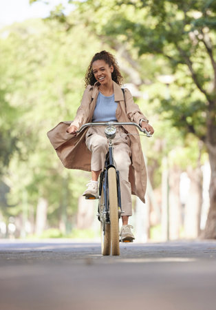 Travel, bicycle and black woman with smile, transport and fitness with cycling, commute and nature. African American female, bike and happy lady outdoor, adventure and riding on weekend break and funの写真素材