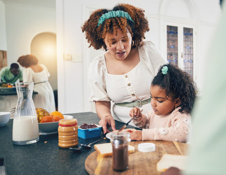 Love, breakfast food and black family kid, mother or people eating meal, bonding and prepare ingredients. Morning cooking, kitchen counter or hungry mom with young child making peanut butter sandwichの写真素材