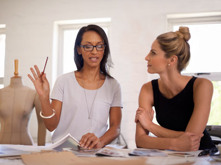 What if we added this...a two attractive designers work on a layout.の写真素材