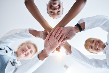 Doctor, group and stack hands in circle for teamwork portrait, happiness or support in hospital for...