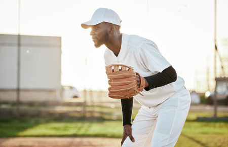 Athlete, baseball player or hand glove on field, sports or arena ground in game, match or competition. Black person, softball or mitt in fitness, exercise or training workout in pitcher stadium flareの写真素材