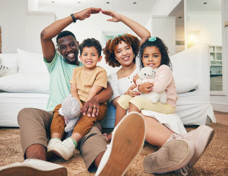 Family, security and insurance with parents and children in portrait, hands together for roof with shelter and safety. Black man, woman and kids, together and love with care, cover for home and lifeの写真素材