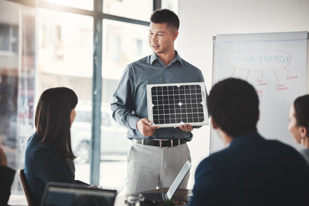 Solar panels, sustainability and man expert in presentation, pitch and conference about renewable energy meeting. Businessman, briefing and teaching corporate people sustainable electricityの写真素材