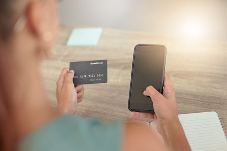 Woman, smartphone and credit card for online shopping, banking service and payments. Female customer, client and consumer with card for transactions, ecommerce and virtual purchase with phone in homeの写真素材