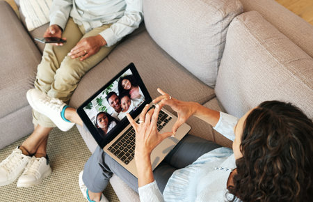 People on video call, family and heart hand with love, laptop screen and communication, grandparents and bonding. Emoji, connection and hands, relax at home with virtual chat in lounge top viewの写真素材