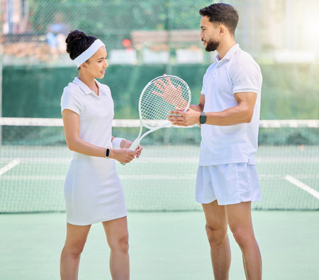 Tennis court, coach or couple talking about sports game, tips and performance after exercise, training and workout. Man coaching woman outdoor for fitness, tennis and health before sport competitonの写真素材