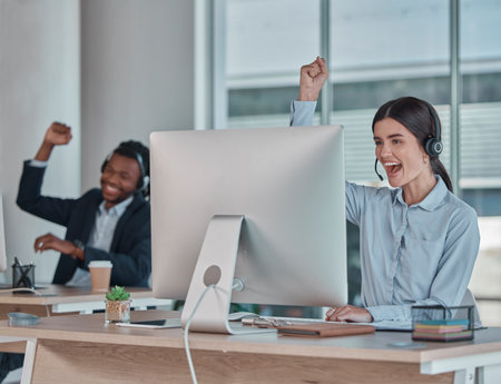 Business woman, call center and team celebration for winning, promotion or sale in telemarketing at office desk. Happy female consultant celebrating victory, good news or success at the workplaceの写真素材