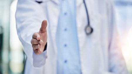 Doctor, handshake and greeting hand gesture to welcome, onboarding and partnership by medical worker in hospital. Closeup, one and person or healthcare professional offer agreement for interviewの写真素材