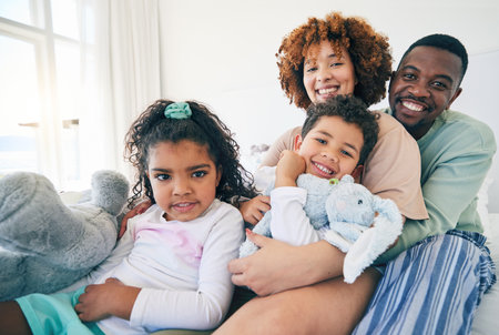 Big family, portrait and bedroom with a mom, dad and children together in morning. Group hug, happiness and smile in a house with parent love, support and bonding with kids, mom and father at homeの写真素材