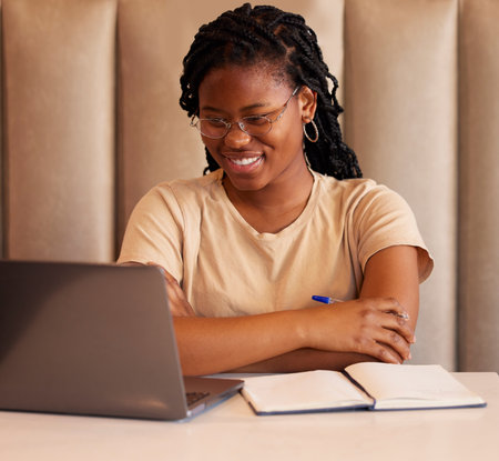 Laptop, studying black woman or student reading college email, university application or remote online education. Planning, e learning and gen z person on computer at restaurant for internet researchの写真素材