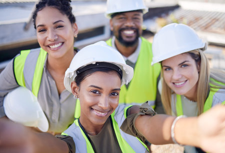 Selfie, engineer and staff outdoor, smile and construction site for real estate, new project and industrial. Portrait, coworkers and happy employees with success, hard hat for safety and managementの写真素材