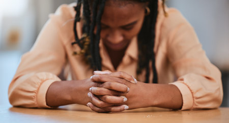 Hands together, business and black woman tired, stress and overworked with burnout, mental health and employee with anxiety. African American female, lady or entrepreneur with depression and thinkingの写真素材