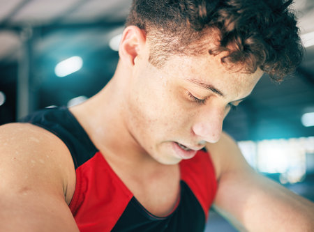 Fitness, sweat and man in gym, tired and exercise with wellness, healthy lifestyle and training. Sports break, male and athlete sweating, drops and exhausted after practice, workout and breathingの写真素材