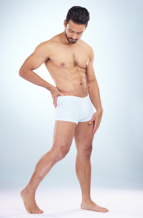 Fitness, underwear or man in studio for training, body exercise or bodybuilding workout for wellness. White background, motivation or healthy male model body builder with muscle development or goalsの写真素材