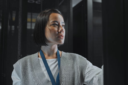 Serious, maintenance or IT woman in server room for analysis, engineer working in data center....