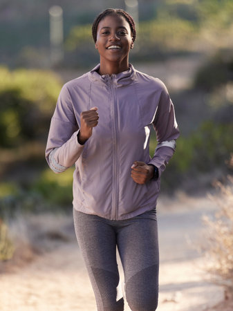 Fitness, running and black woman on mountain for exercise, marathon training and workout in nature....