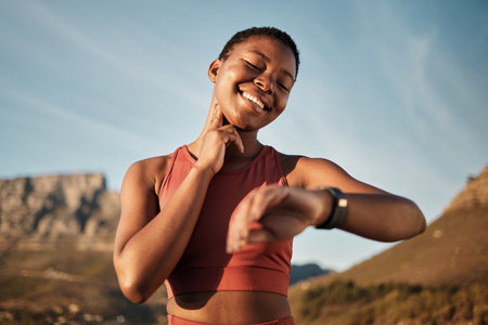 Heart rate, smartwatch and mountain with black woman running for fitness tracker, cardio and monitor goals. Time, sports and workout tracker with girl runner checking wearable technology for progressの写真素材