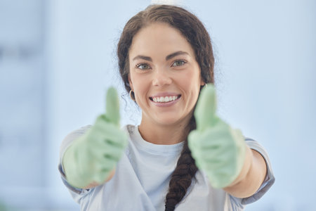 Thumbs up, woman and happy for success of cleaning service, motivation and like emoji in Russia. Portrait, smile and cleaner with thumb up hands for good housekeeping, satisfaction review and trustの写真素材