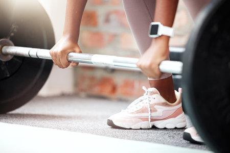 Weightlifting, start and hands of a woman at the gym, health exercise and workout training for fitness. Sports, wellness and athlete with weights for power, strong muscles and bodybuilder sportの写真素材