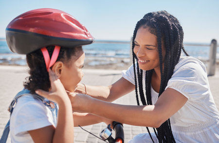 Mother, child or bike helmet help by beach, city ocean or sea in riding safety, learning security or fun activity protection. Happy smile, bonding mom or girl bicycle and Brazilian cycling transportの写真素材