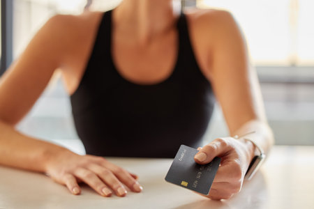 Hands, credit card and payment at gym for fitness membership or exercise subscription. Fintech, ecommerce and athlete or woman buying or paying for workout or training at exercising club for health.の写真素材