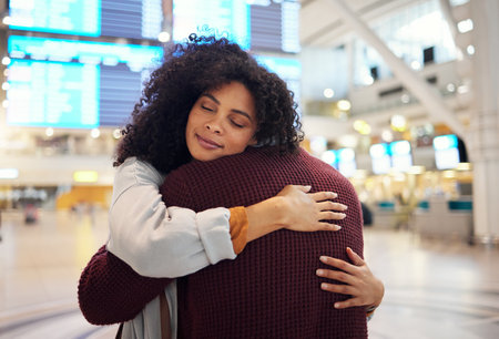 Couple, hug and embracing goodbye at airport for travel, trip or flight in farewell for long distance relationship. Man and woman hugging before traveling, departure or immigration and arrivalの写真素材