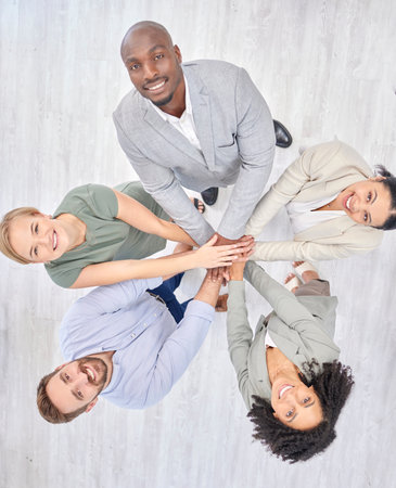 Teamwork, overhead and business people in diversity, support and solidarity together hands stacked in office. Successful, success and portrait of collaboration by corporate team or staff in communityの写真素材