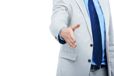 Welcome to the team. Cropped studio shot of a businessman with his arm extended to shake hands isolated on white.の写真素材