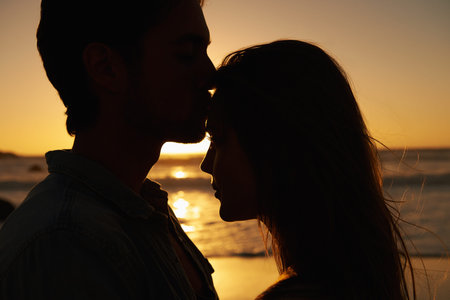 Youre everything to me. A young couple expressing their love at sunset on the beach.