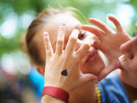 Making a fashion statement. A young woman with a heart tattoo on her hand.の写真素材