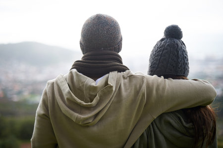 This view is inspiring. An affectionate young couple admiring a beautiful view of the cityscape...