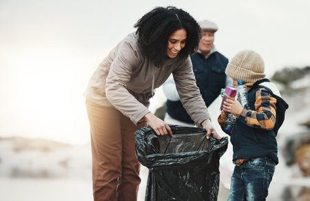 Beach cleaning, plastic and family with child volunteer for education, learning and community support. Happy people, mother and kid help with plastic waste, garbage or trash in climate change projectの写真素材