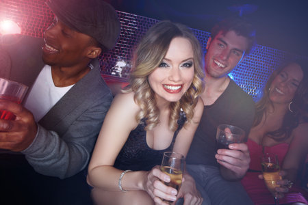 Party, happy hour and woman portrait for new year and social event at a disco nightclub. Champagne, dj set and alcohol drink of friends smile ready to celebrate the night with dance and happinessの写真素材