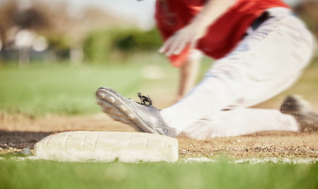 Man, foot or slide on sports baseball field in game, match or competition challenge for homerun motion blur. Athlete, shoes or softball player feet in fast run, fitness or exercise workout on groundの写真素材