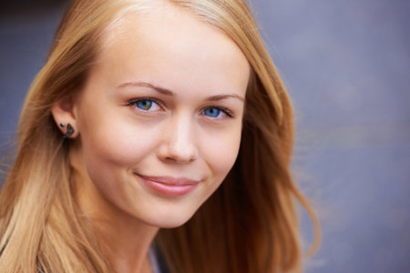 Beauty, happiness and portrait of woman with smile for wellness, positive mindset and relaxing. Youth, cosmetics and face of young teenager from Ireland with healthy skin, blonde hair and blue eyesの写真素材