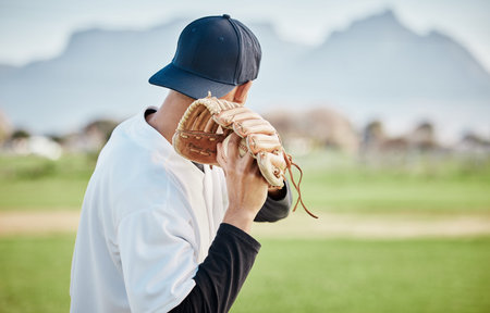 Pitcher, back view or baseball player training for a sports game on outdoor field stadium. Fitness,...