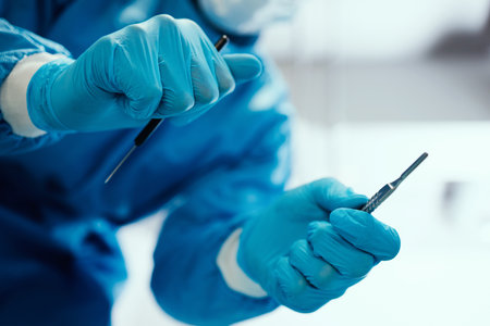 Healthcare, surgeon and hands with a scalpel for procedure in an operating room at hospital. Closeup of doctor or nurse with medical equipment for surgery in emergency room at medicare clinic center.の写真素材